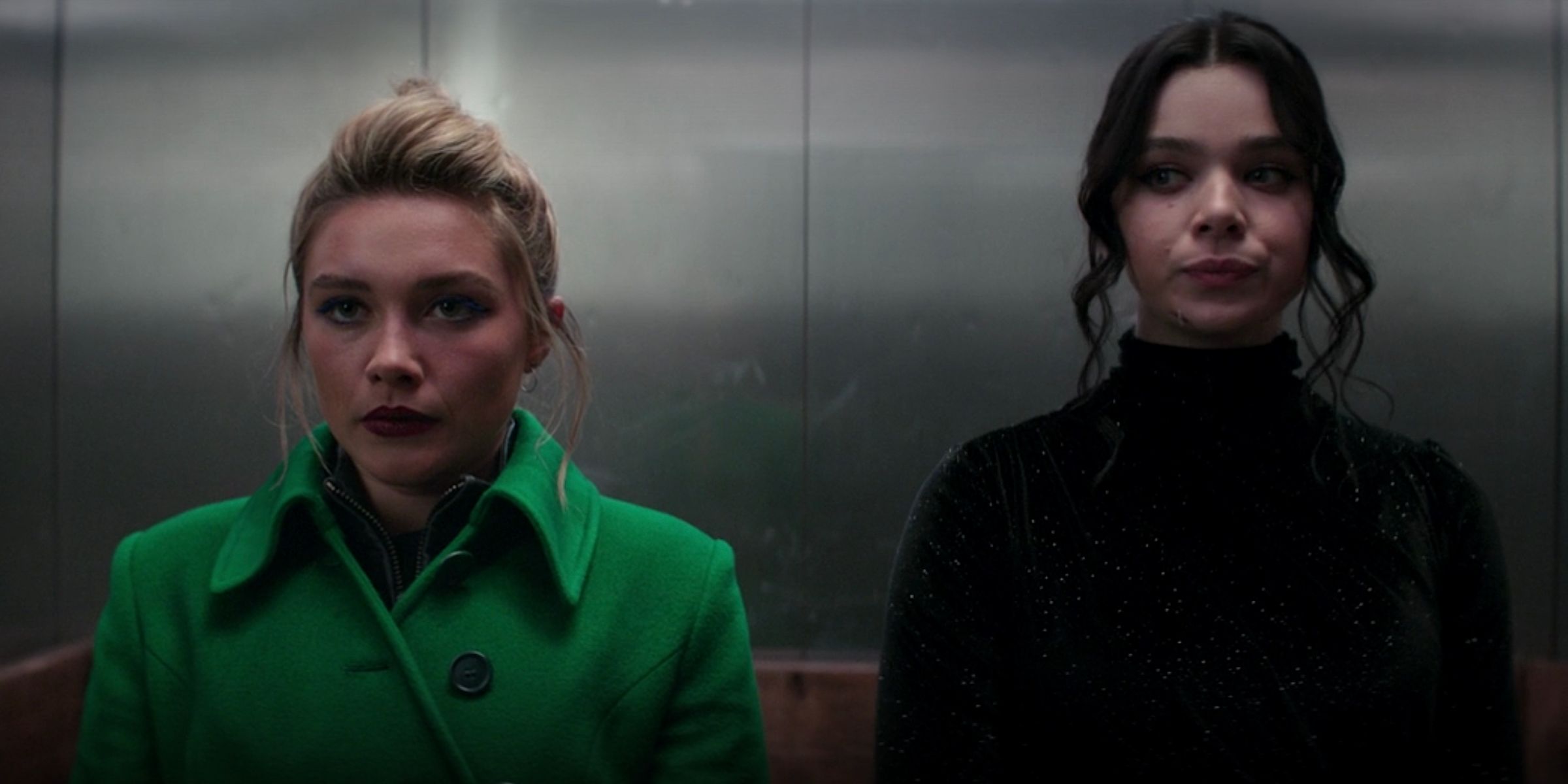 Yelena Belova (Florence Pugh) and Kate Bishop (Hailee Steinfeld) standing next to each other in an elevator in Hawkeye.