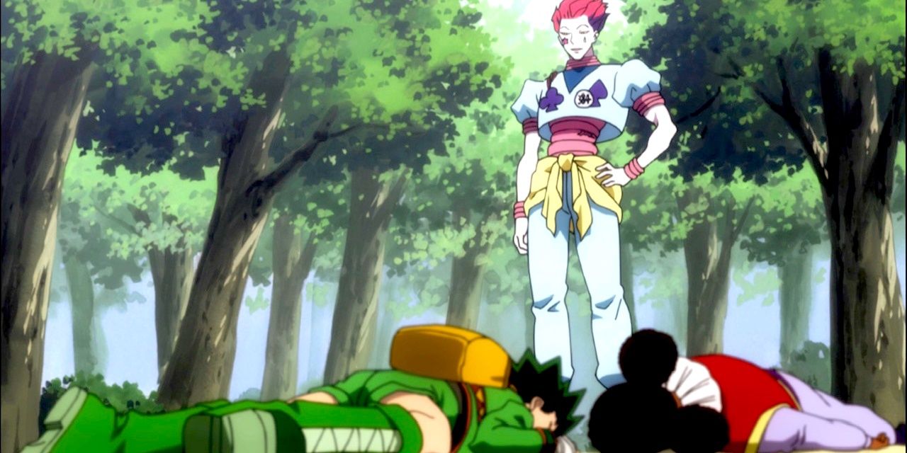 Hisoka stands over Gon after giving him his Hunter Exam badges