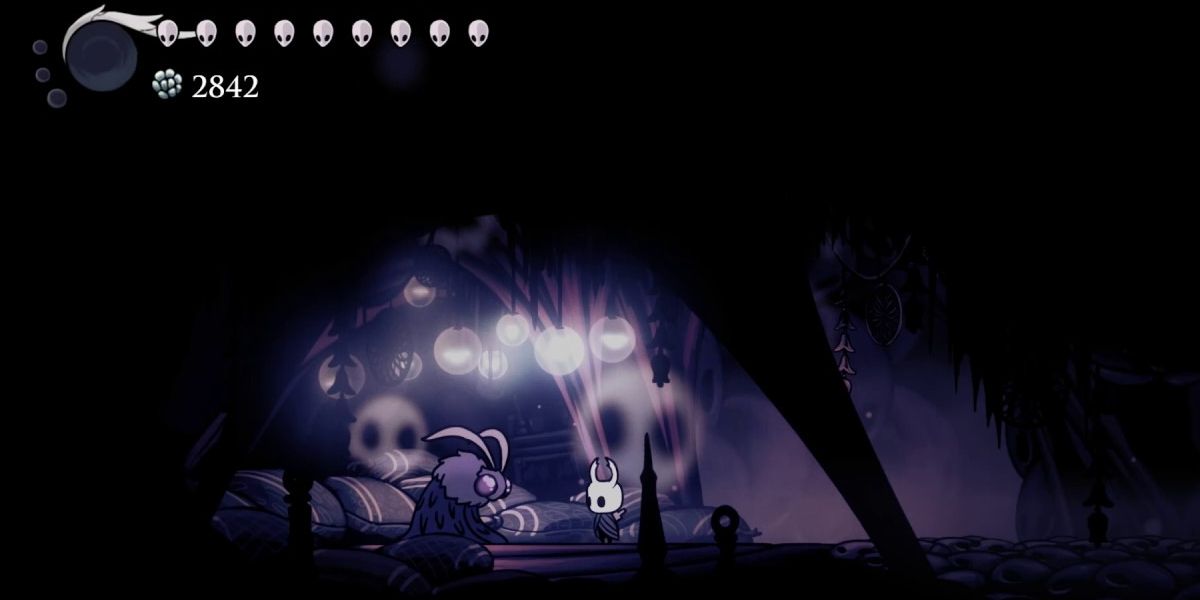 Hollow Knight in front of the Seer in the Resting Grounds.