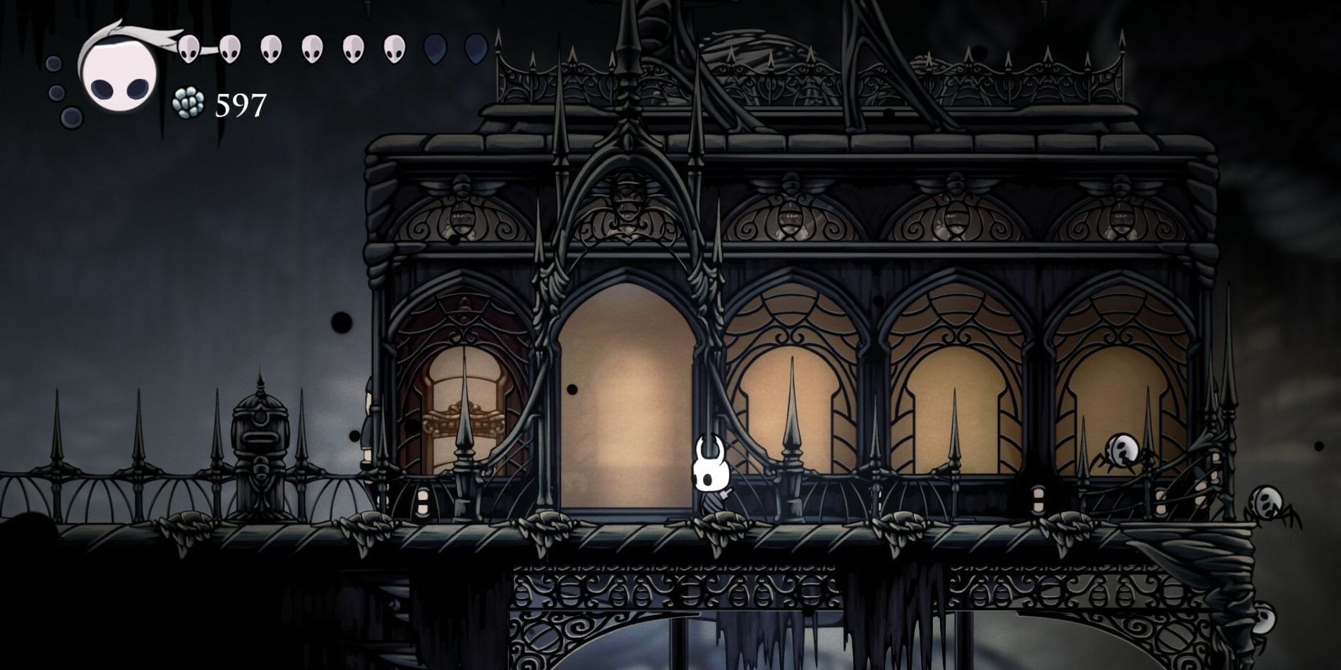 Hollow Knight in front of the Tramway at the Ancient Basin.