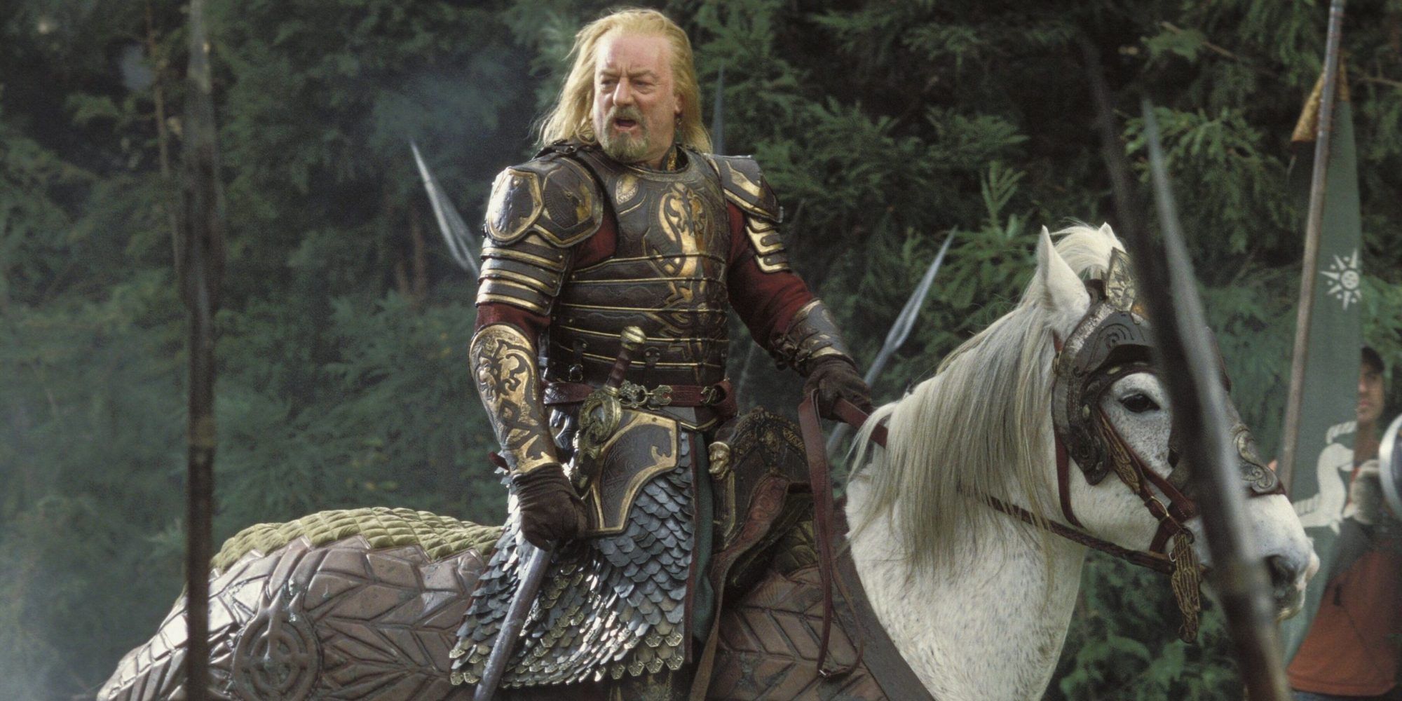 King Theoden riding his horse into battle