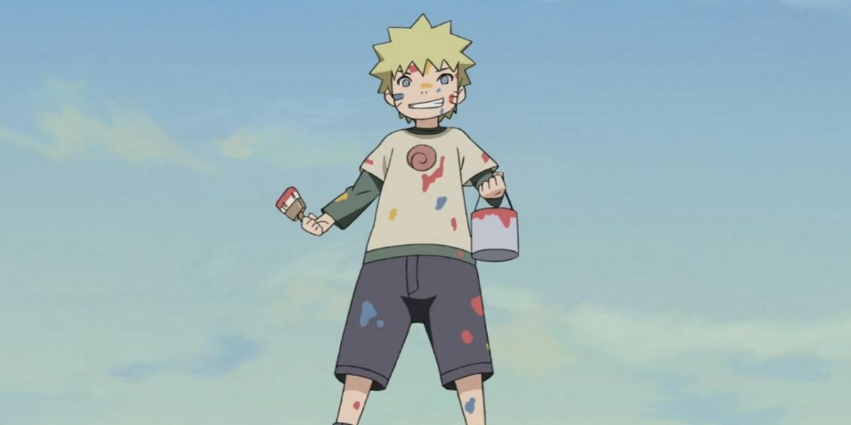 Young Naruto holding a paint brush while covered in paint