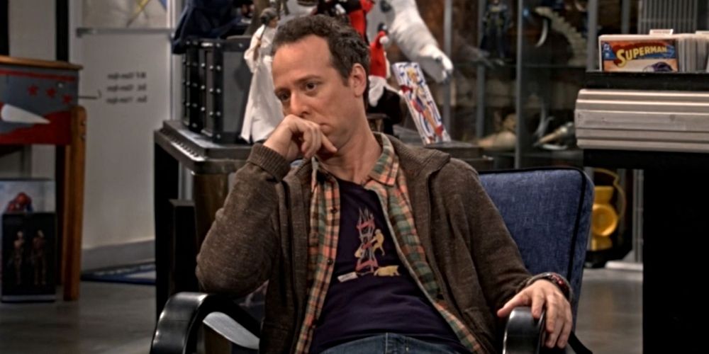 Stuart Bloom sitting in his comic book store in The Big Bang Theory.