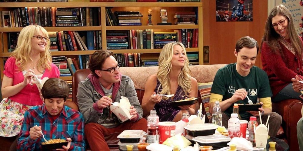 The cast sitting around and eating takeout for one final time twelve years later in The Big Bang Theory