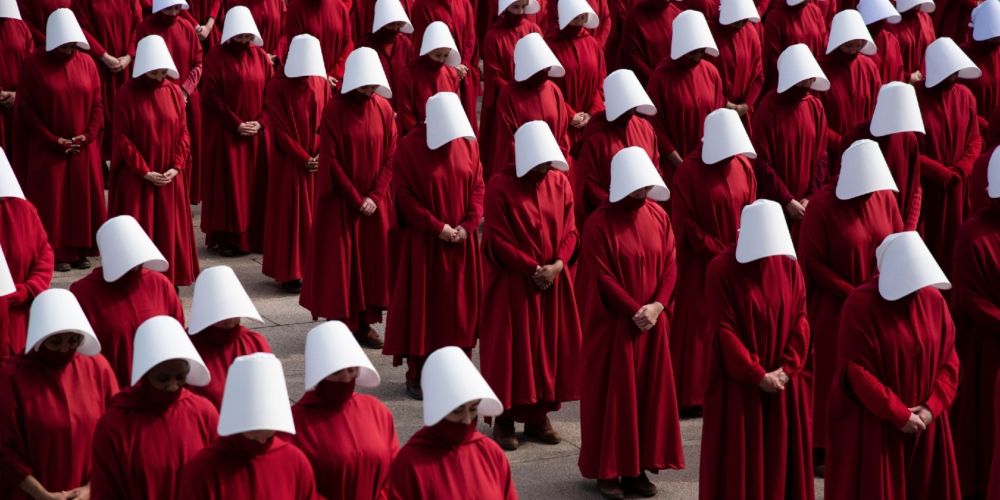 Row after row of handmaids lined up together in the Handmaid's Tale