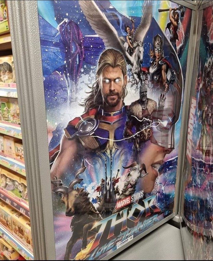 A merchandise poster for Thor: Love and Thunder appears in a store.