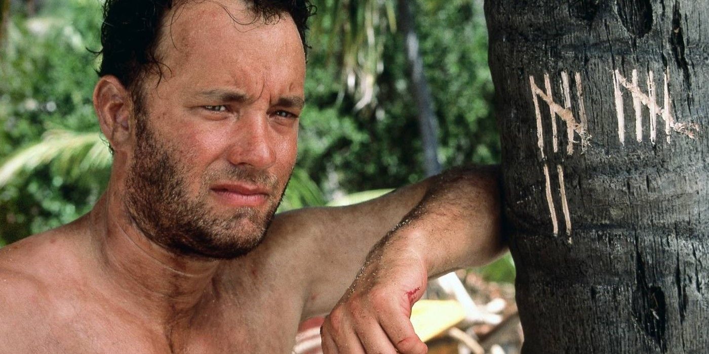 Tom Hanks' Chuck Noland leans against a tree while stranded on an island in Cast Away