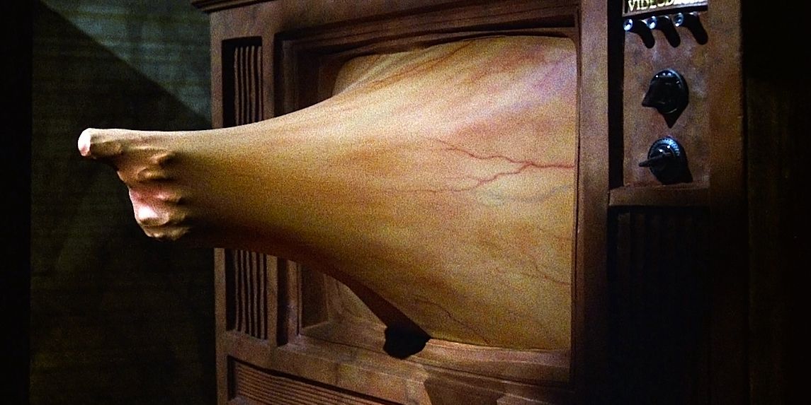 Videodrome's scary TV Screen where practical effects make it look like a gun is coming through the tv screen 