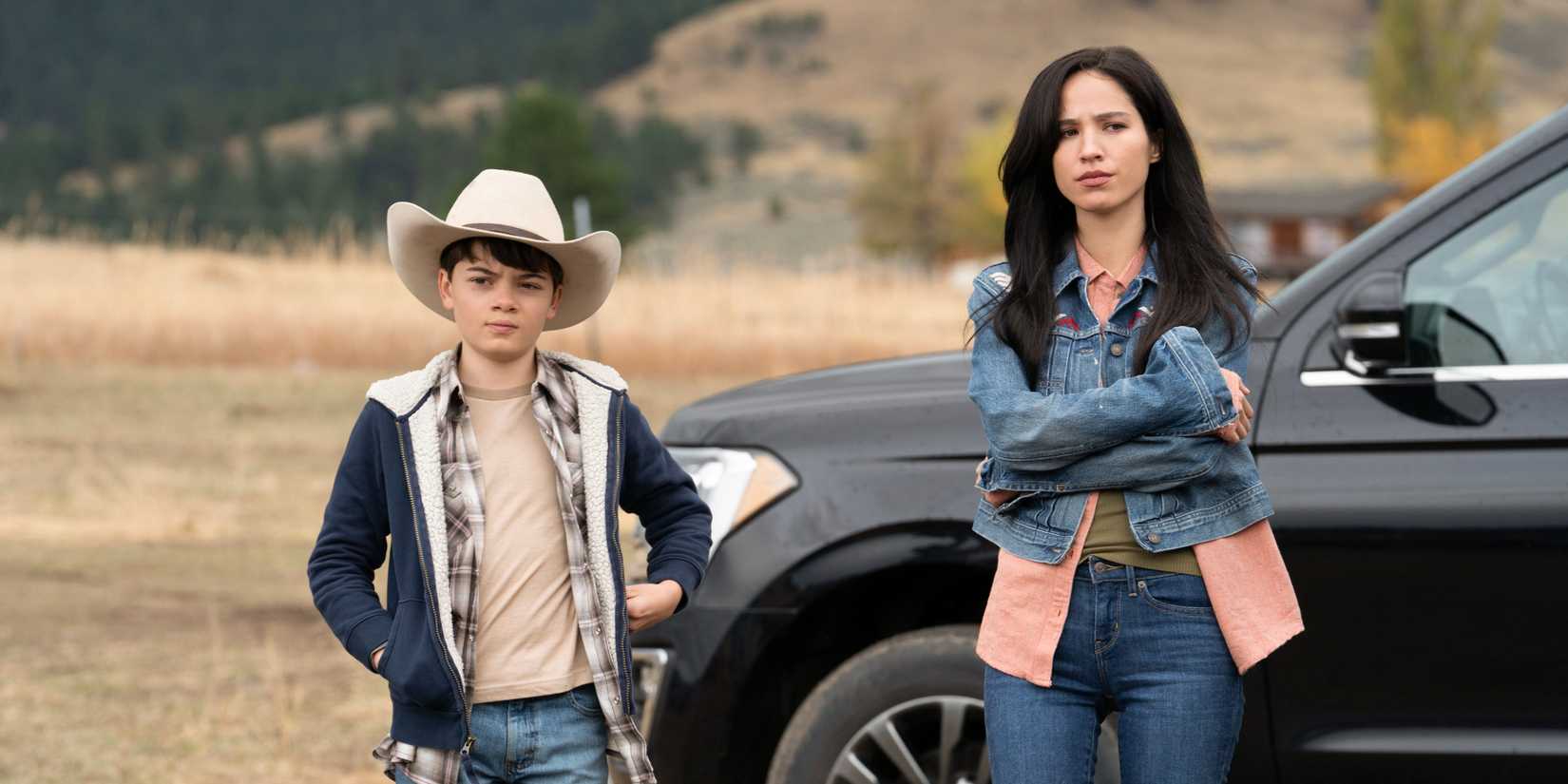 Monica and Tate stand outside a truck in Yellowstone.
