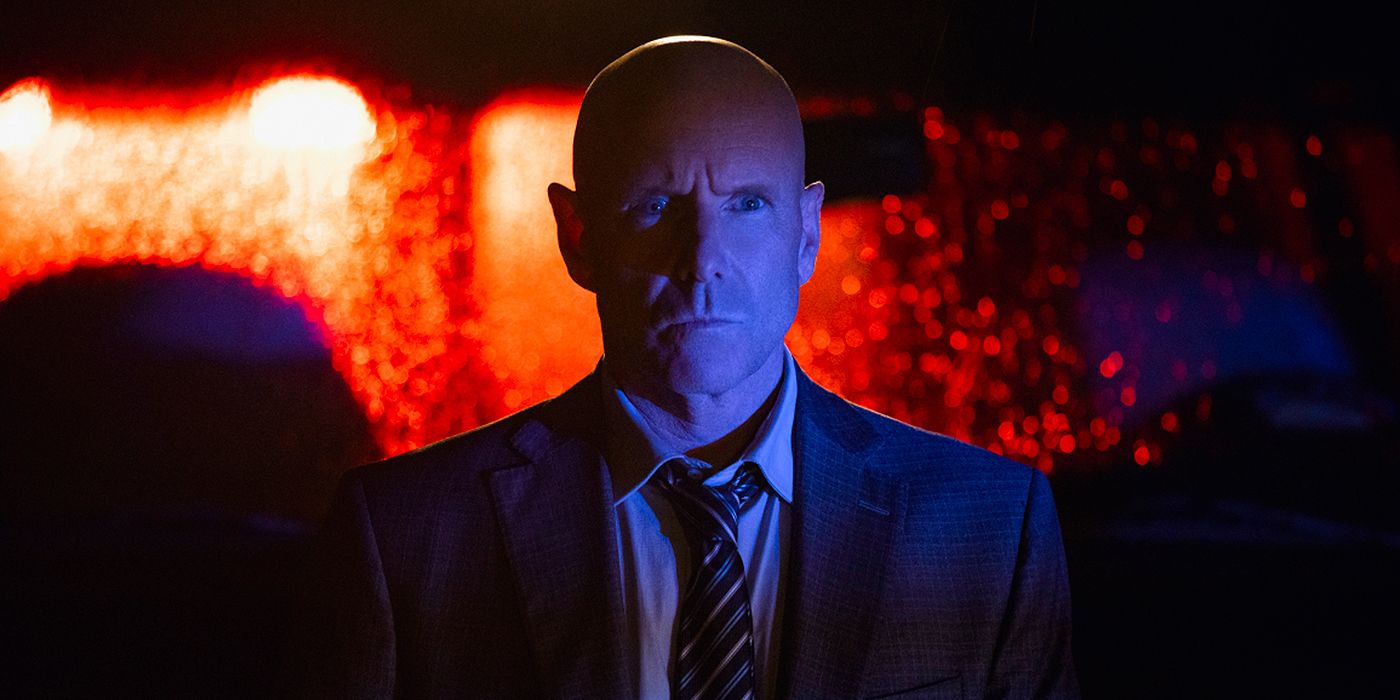Ian Ferguson (played by Hugh Dillon) is shaded by police lights in Mayor of Kingstown