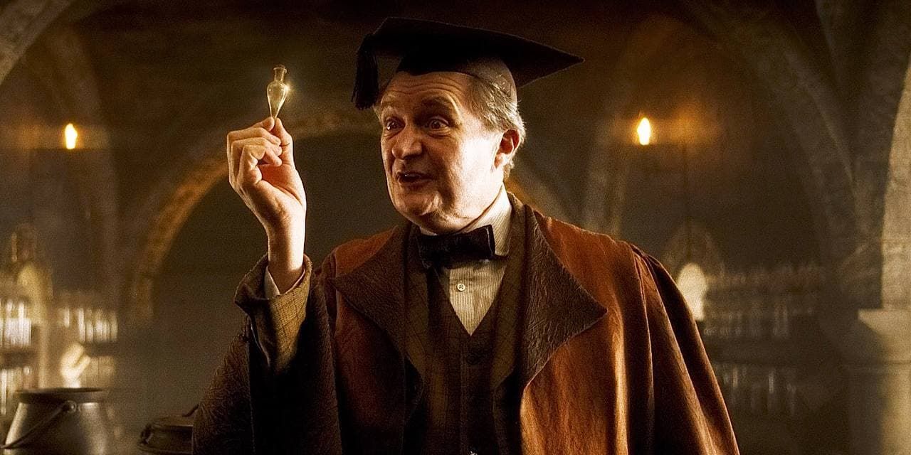 Horace Slughorn from the Harry Potter films speaks while holding a potion vial.