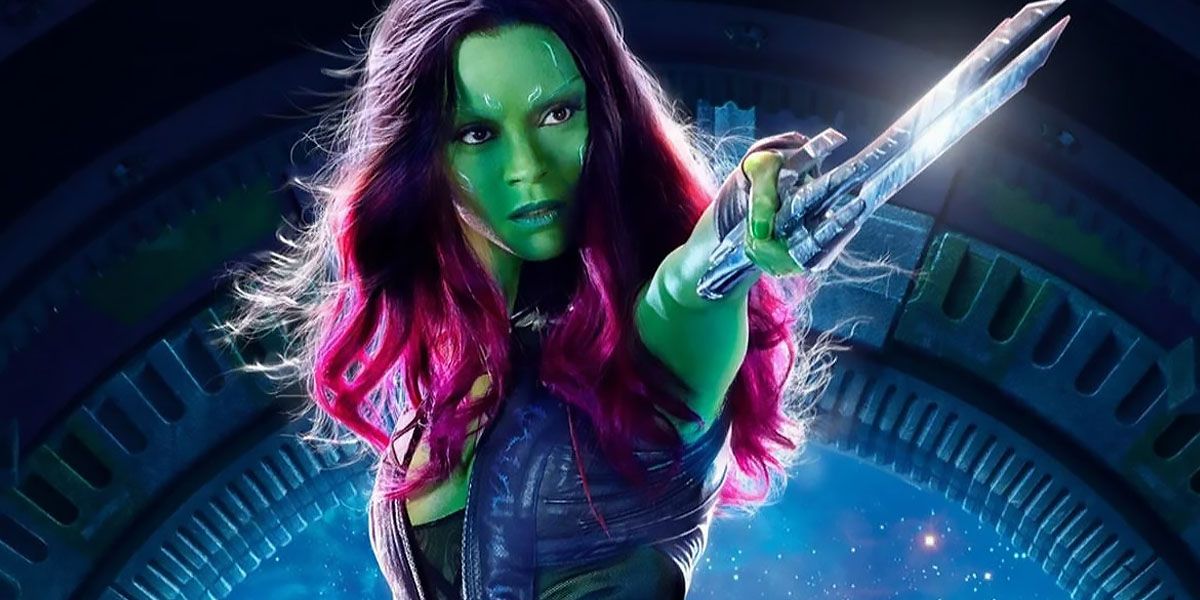 Gamora holds up her weapon