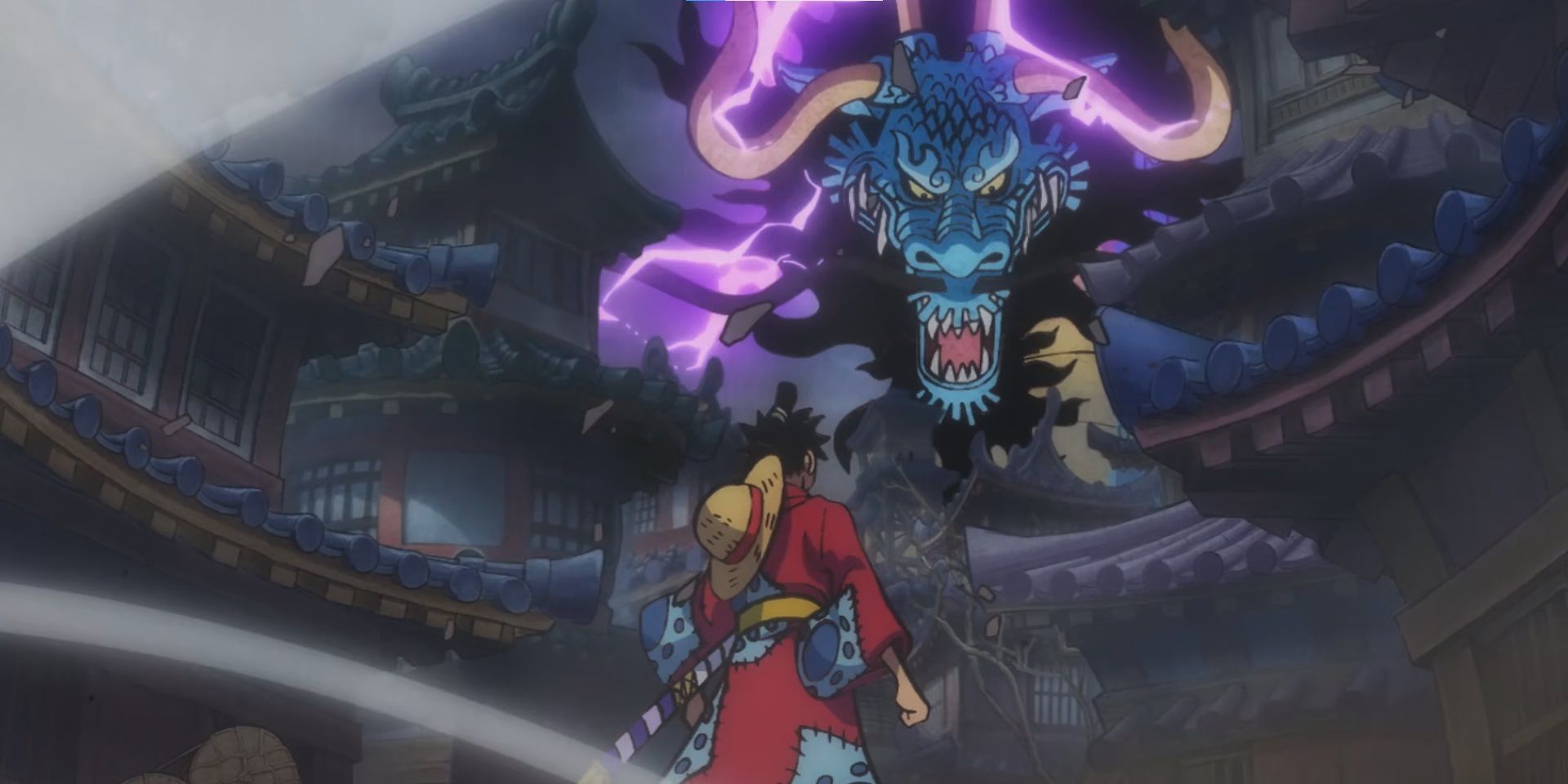 A One Piece anime still shows Kaido loom over Luffy, as he stands by some buildings