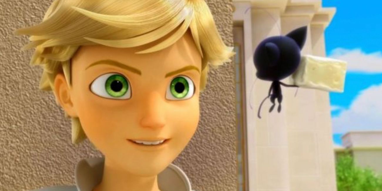 Plagg holds a piece of cheese while talking to Adrien in Miraculous Ladybug