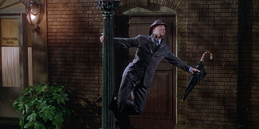 Don Lockwood sings delightedly in the rain in Singing in the Rain movie