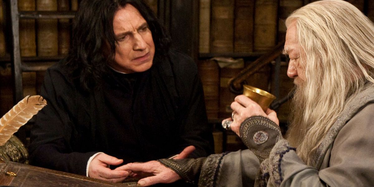 Albus Dumbledore holding a goblet and talking with Severus Snape
