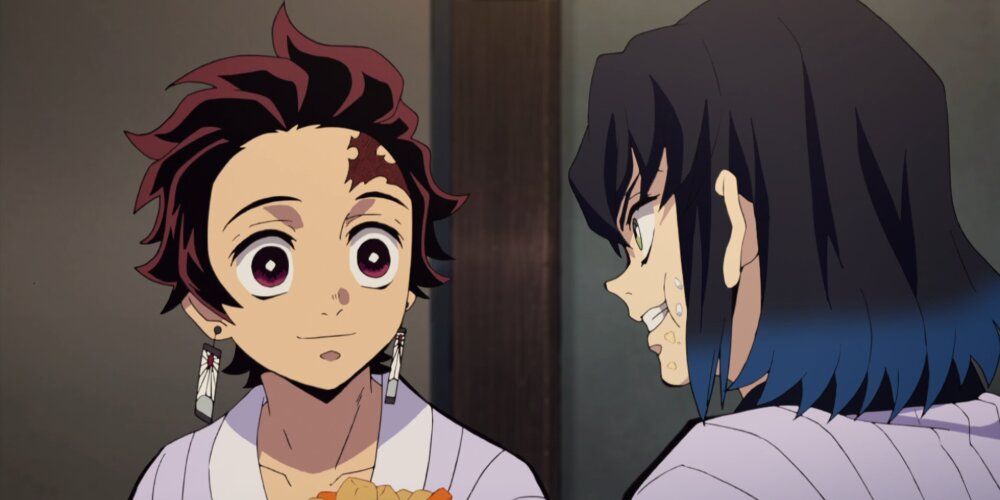 Tanjiro offers Inosuke food while they rest