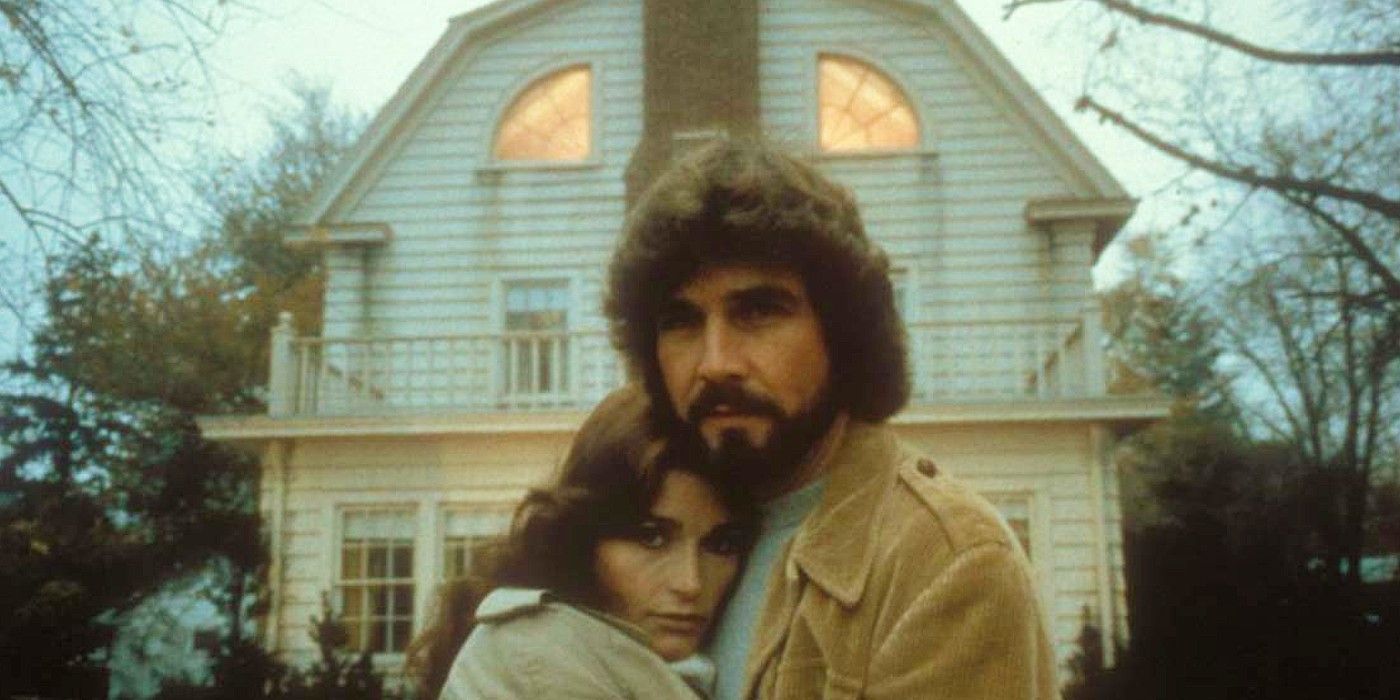 The Lutzs pose in front of their new home in The Amityville Horror