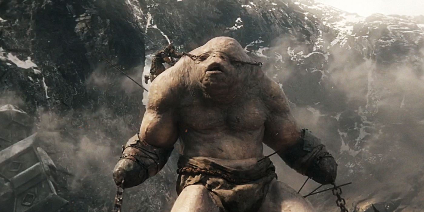 A troll standing in smoky wreckage in The Hobbit 