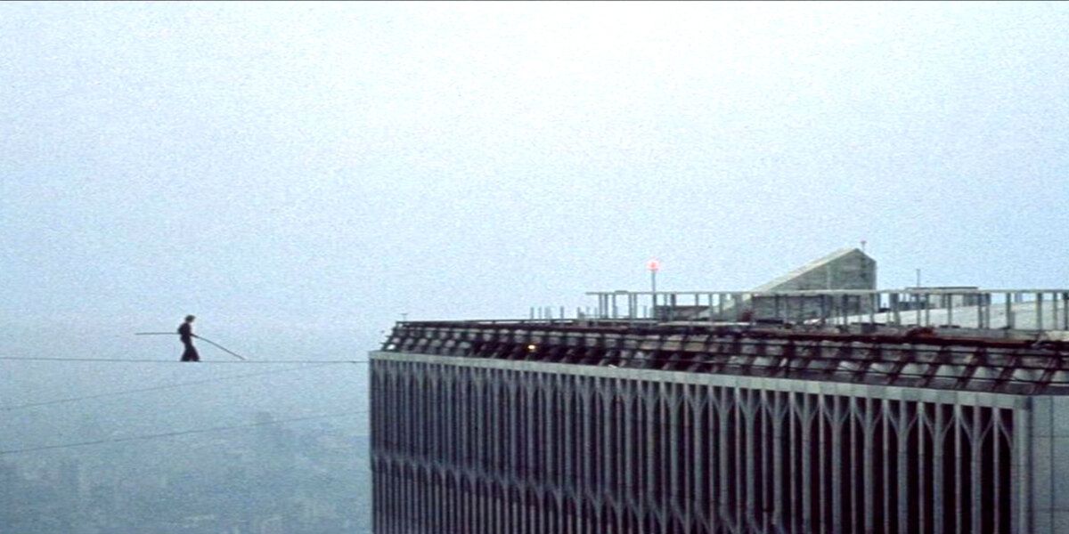 A still image of a man walking a tight rope between buildings in the Man on Wire documentary 