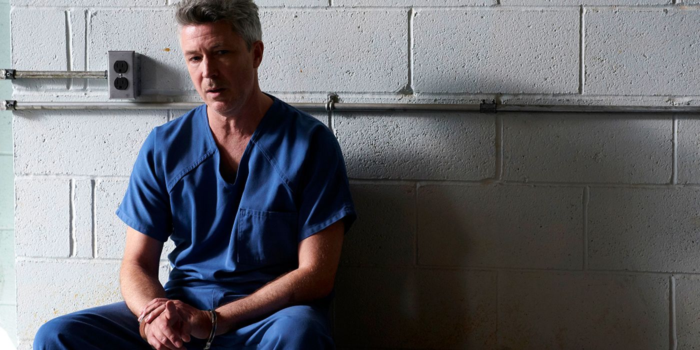Milo Sunter, played by Aiden Gillen, sits in a prison cell during Mayor of Kingstown Episode 9.