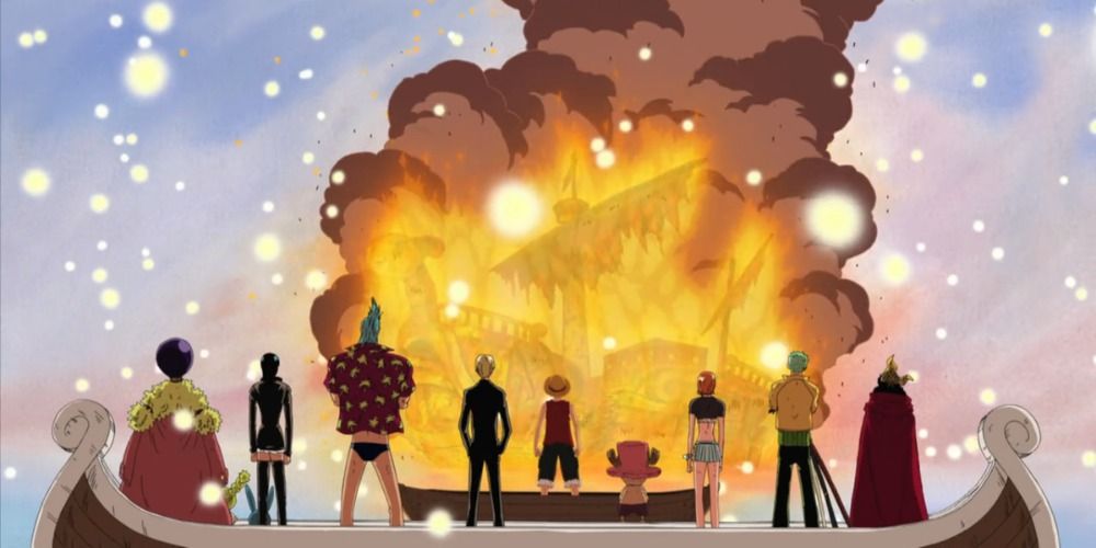Straw Hat Crew standing in front of a burning Going Merry