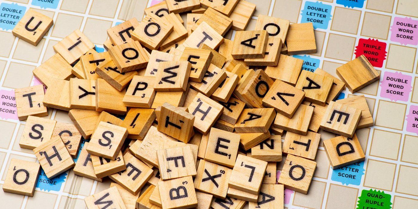 scrabble board with a pile of letters
