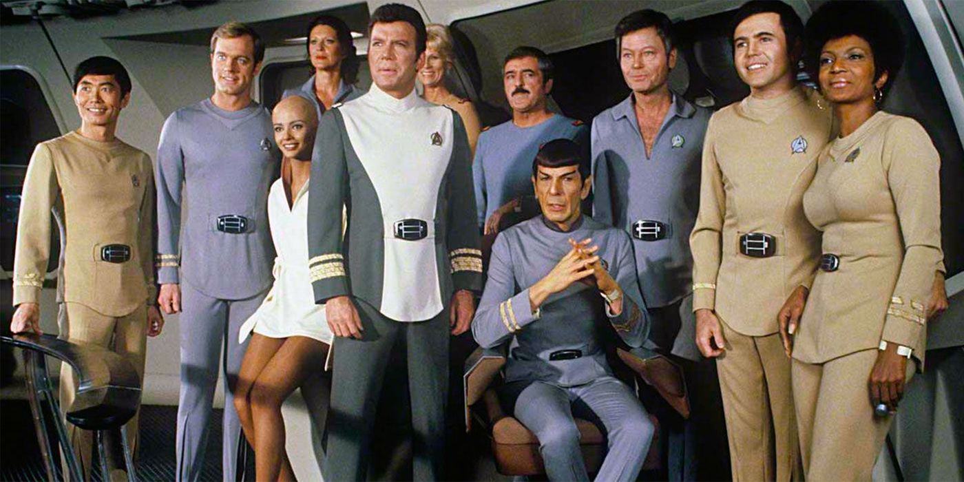 The main cast of Star Trek: The Motion Picture lined up together posing for a picture.