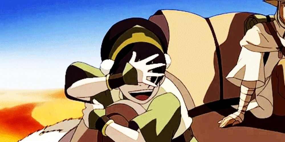 Toph on Appa waving hand over face