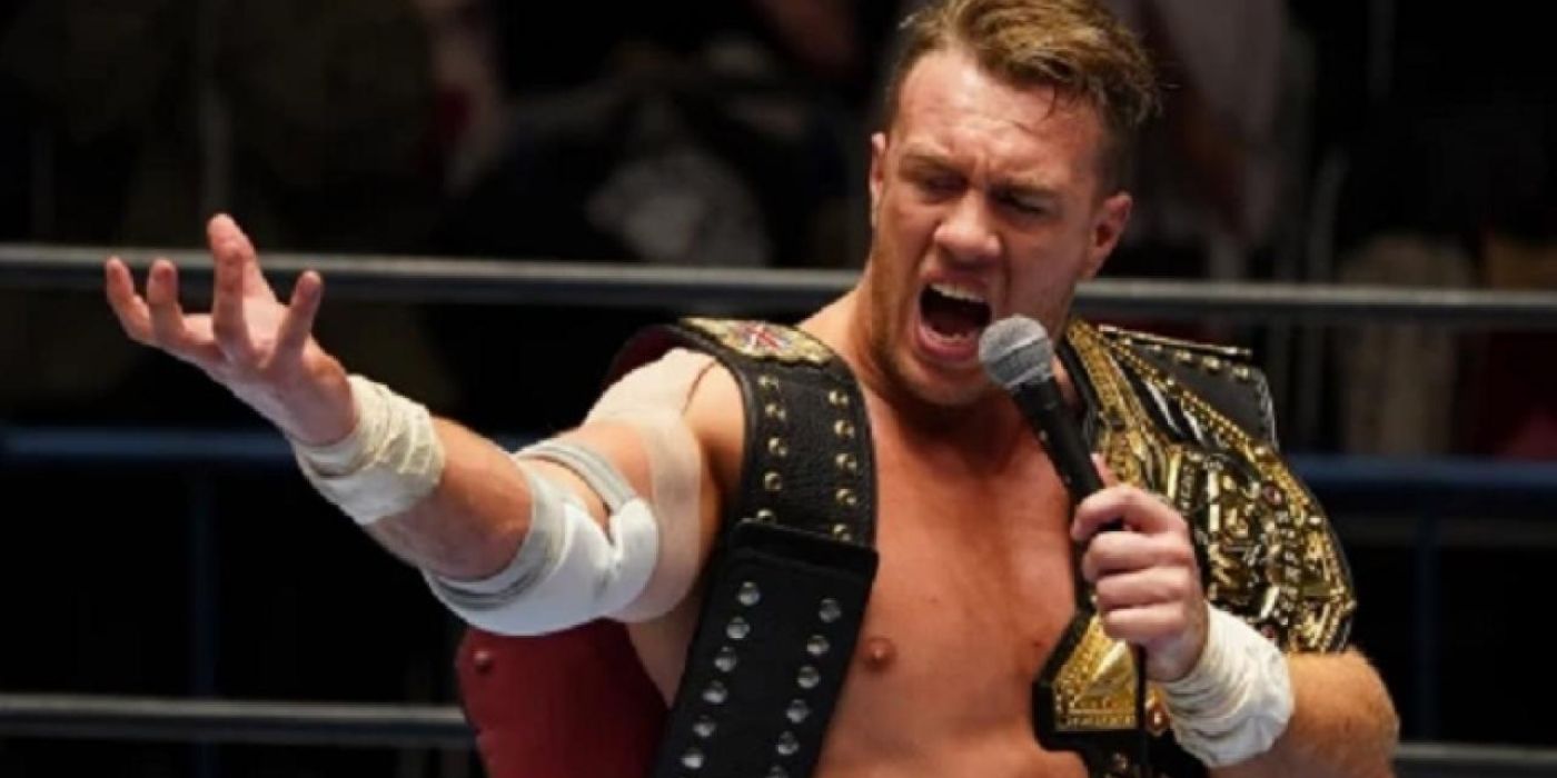 Will Ospreay segurando seus cinturões de campeonato 