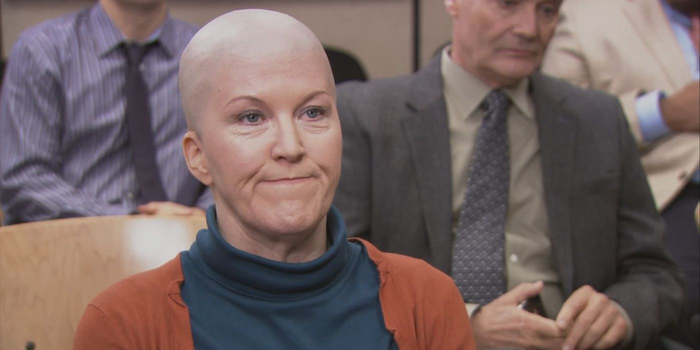 Meredith, played by Kate Flannery, with her head shaved sitting in conference room in The Office