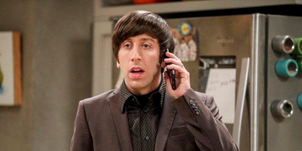 Howard from The Big Bang Theory in his kitchen on the phone, looking shocked.