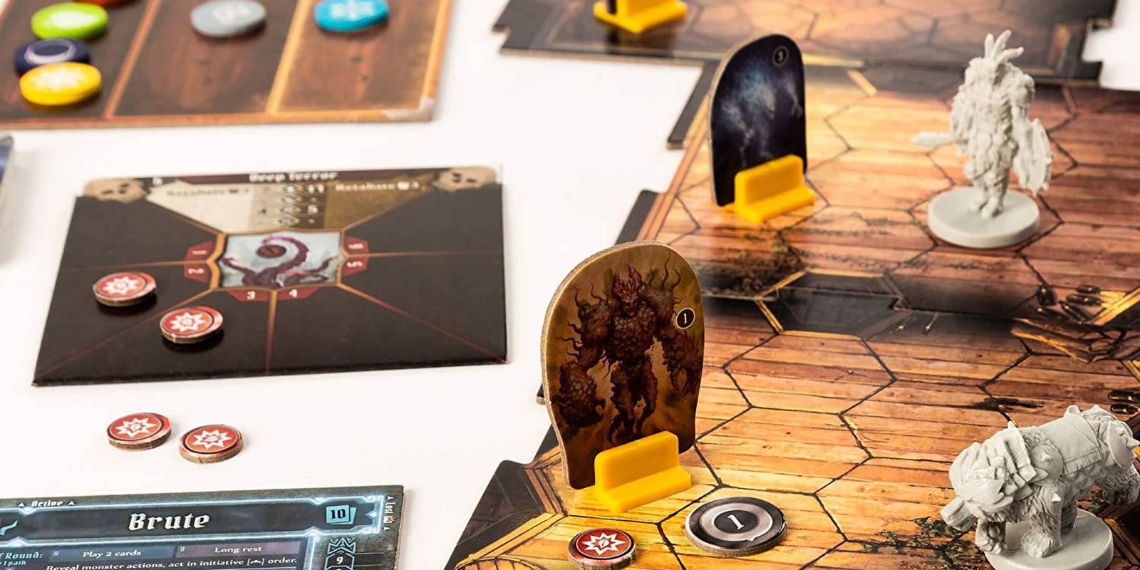 Player characters in combat in Gloomhaven fantasy board game.