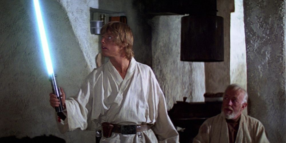 Luke Skywalker wielding Anakin Skywalker's lightsaber in Star Wars Episode IV A New Hope