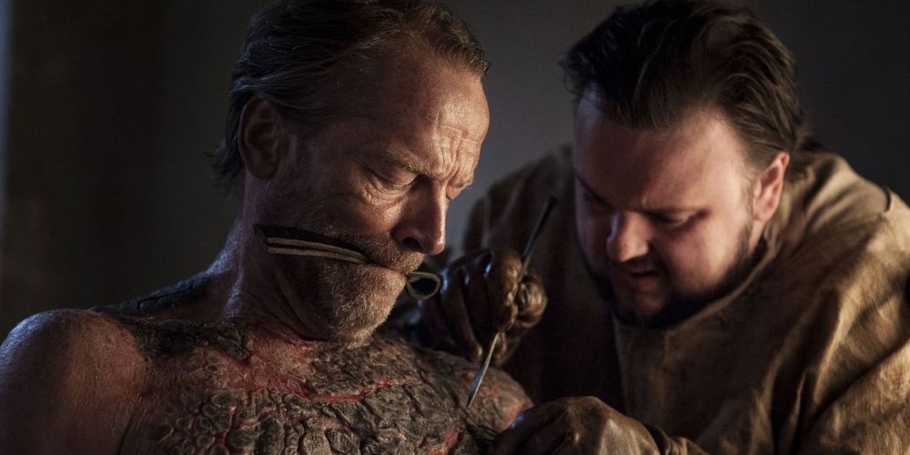 Samwell Tarly removes the greyscale from Jorah Mormont in Game of Thrones