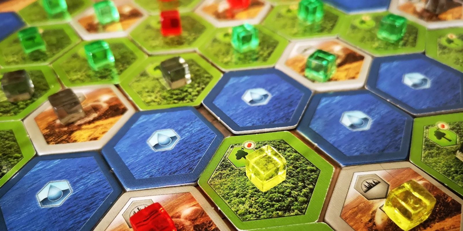 Pieces from several players on areas in Terraforming Mars board game