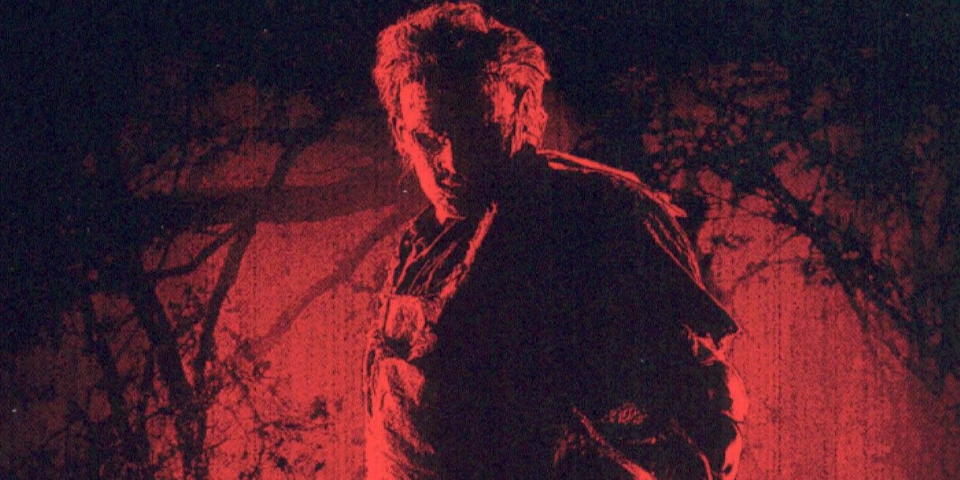 Leatherface standing with red around him.