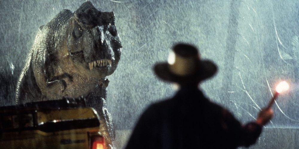Dr. Grant stares down a Tyrannosaurus Rex in the rain, in Jurassic Park