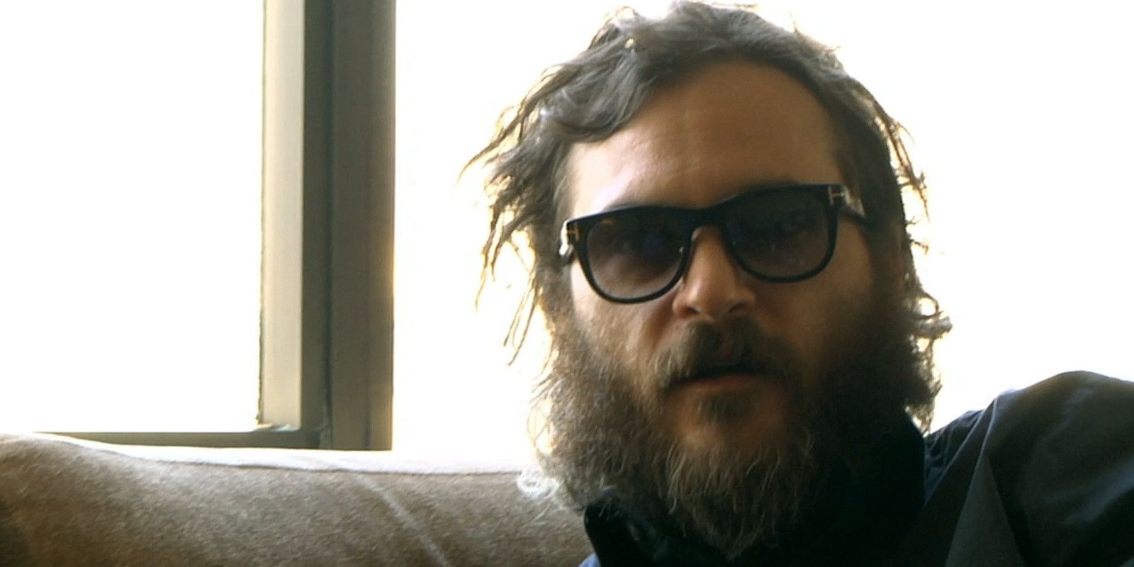 Joaquin Phoenix shaded and dishevelled playing himself in I'm Still Here