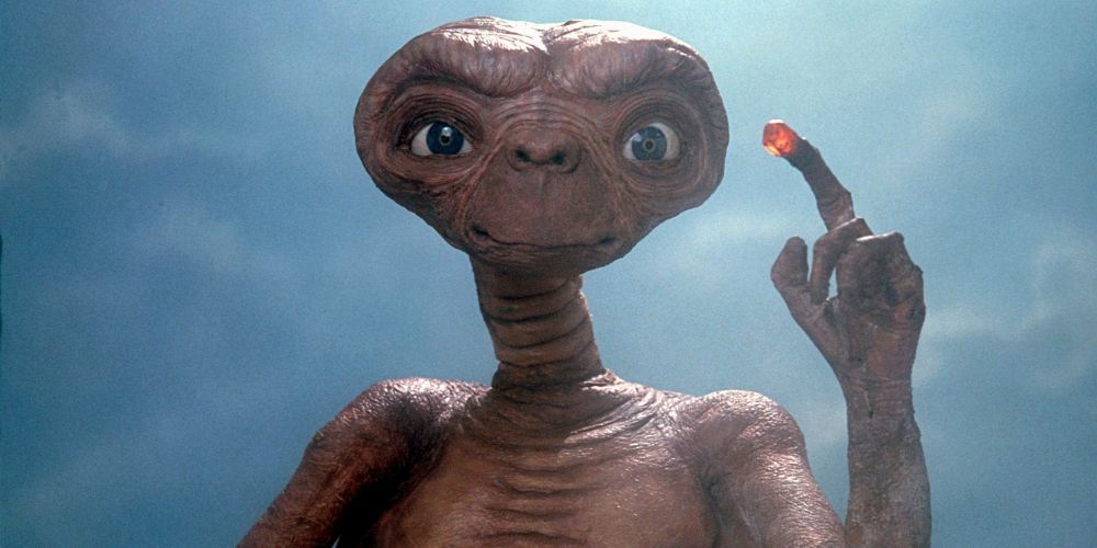 E.T. pointing at Elliott with his glowing finger in E.T. the Extraterresetrial.