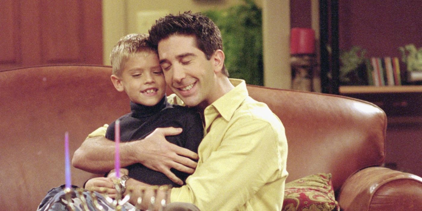 A Friends still shows Ross hugging Ben while sat on the sofa