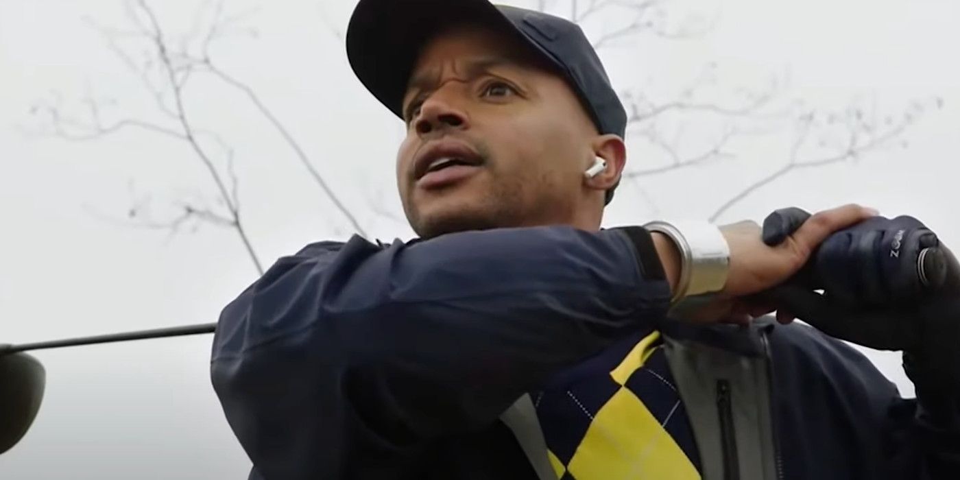 Donald Faison as Booster Gold in Legends of Tomorrow wearing a cap and looking concerned.