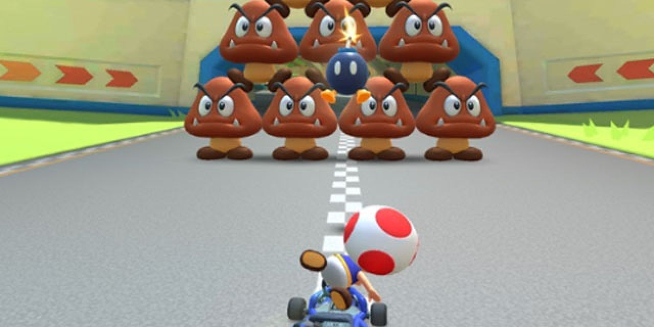 Toad throwing a Bob-omb at a pyramid of Goombas in Mario Kart Tour.