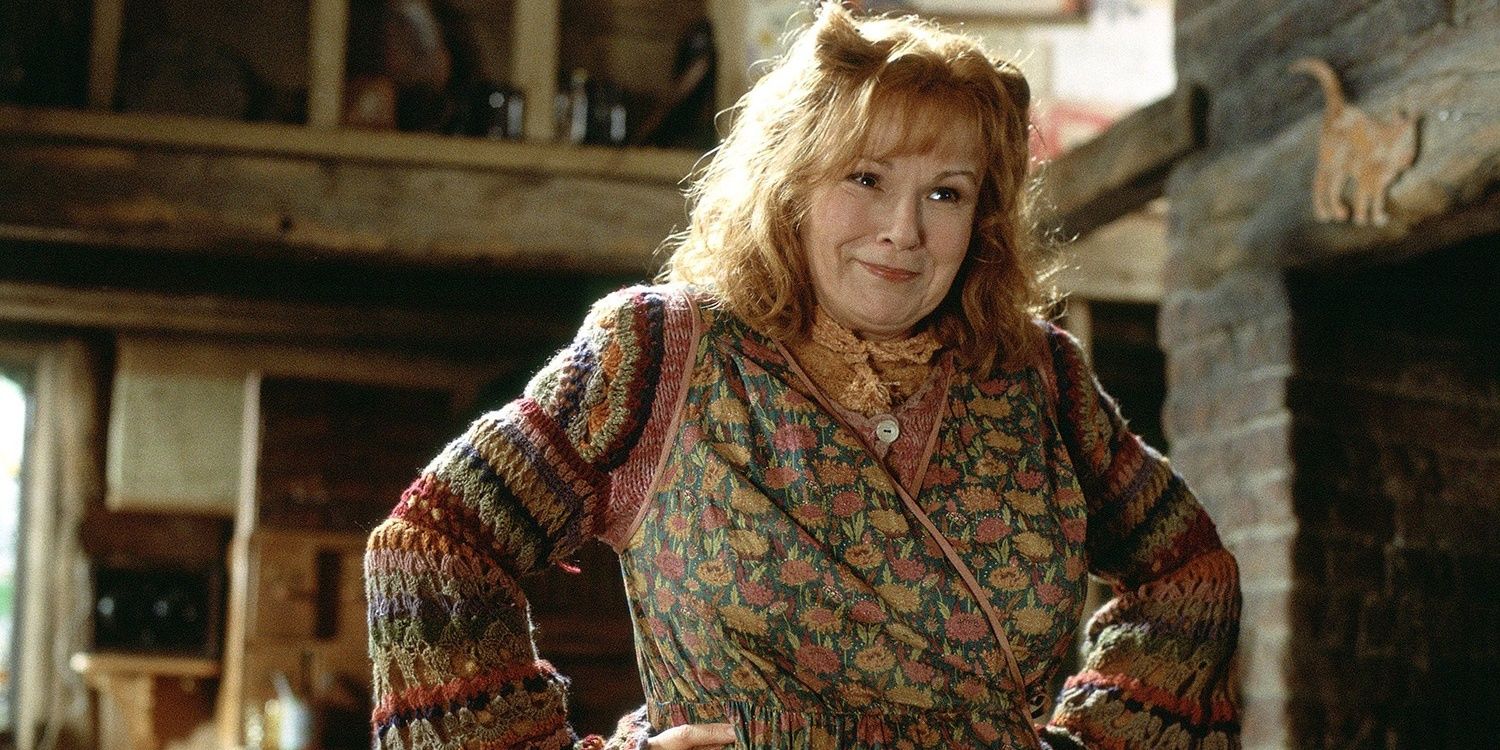 Molly Weasley places her hands on her hips and smiles at Harry Potter