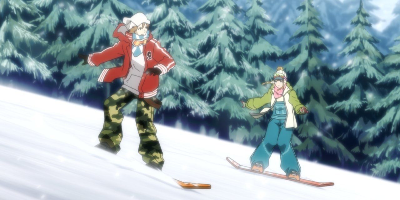 Yoskue and Chie snowboarding down a hill