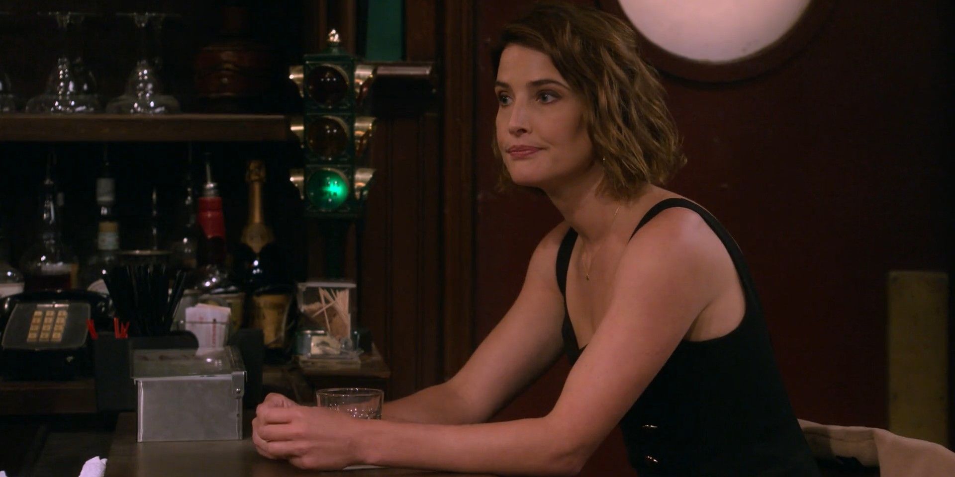 Robin sitting alone at the bar in How I Met Your Father