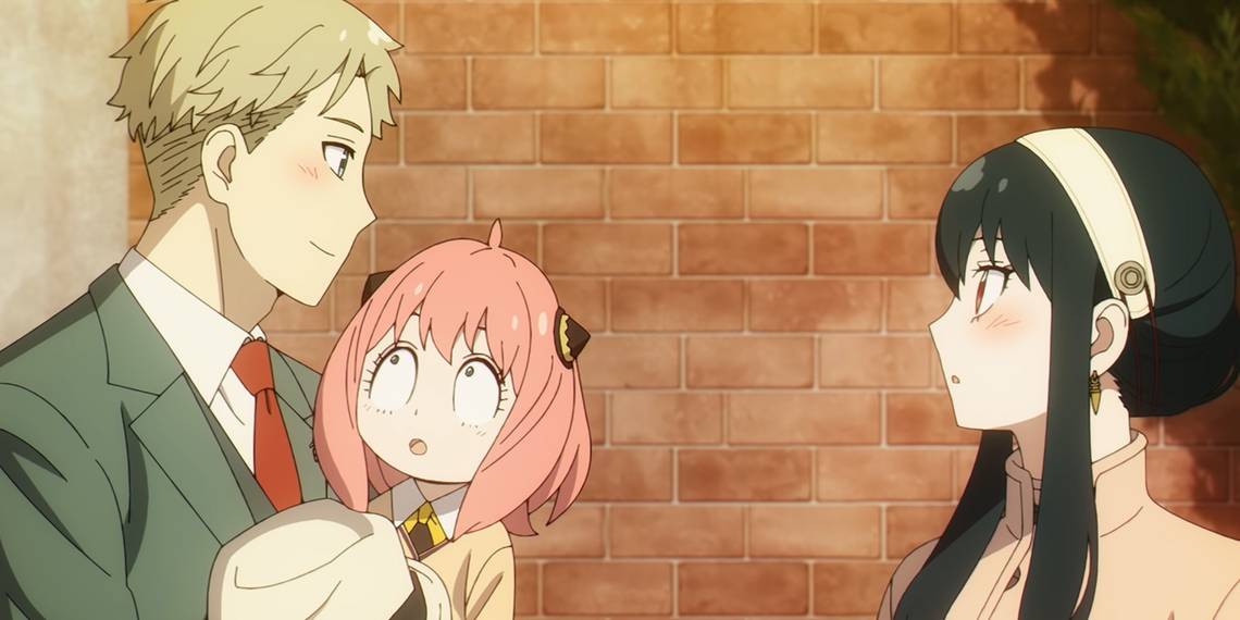Screengrab of Spy x Family depicting Loid and Yor gazing at each other while a wide-eyed Anya stares up at Loid from his arms. A brick wall can be seen behind them.