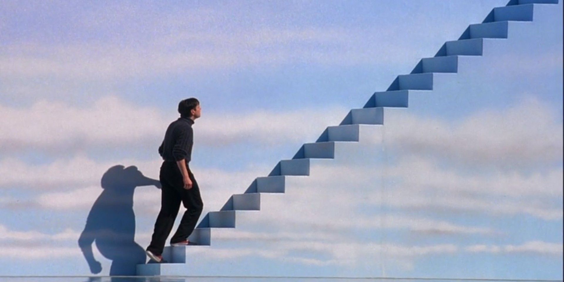 Jim Carrey as Truman ascending steps into the sky in The Truman Show