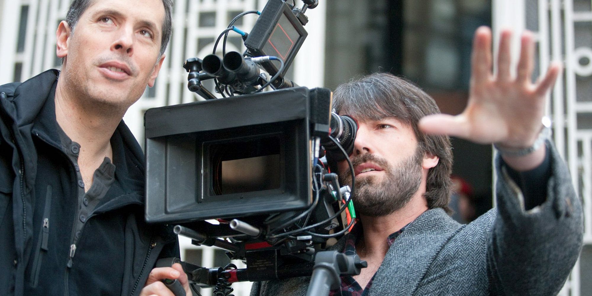 Ben Affleck holding a camera directing on the set of Argo.