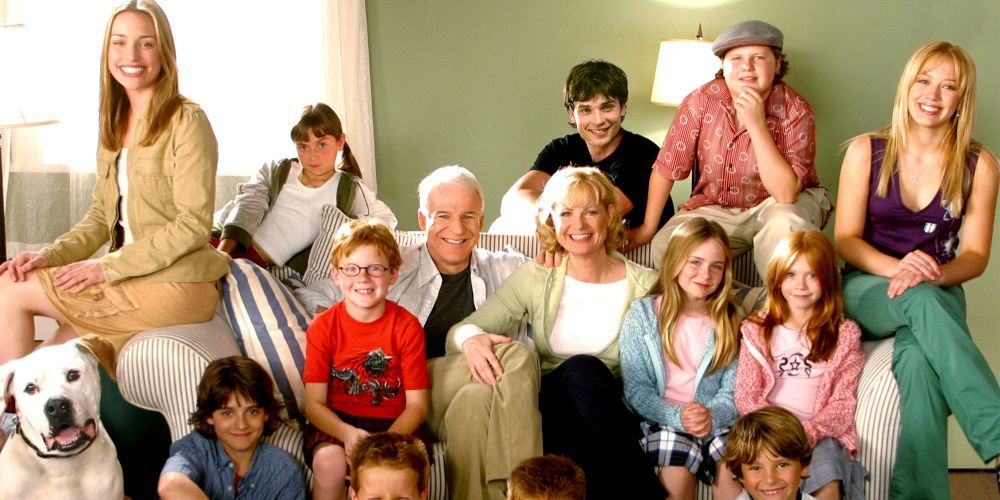 The Baker family sitting on a couch in Cheaper by the Dozen